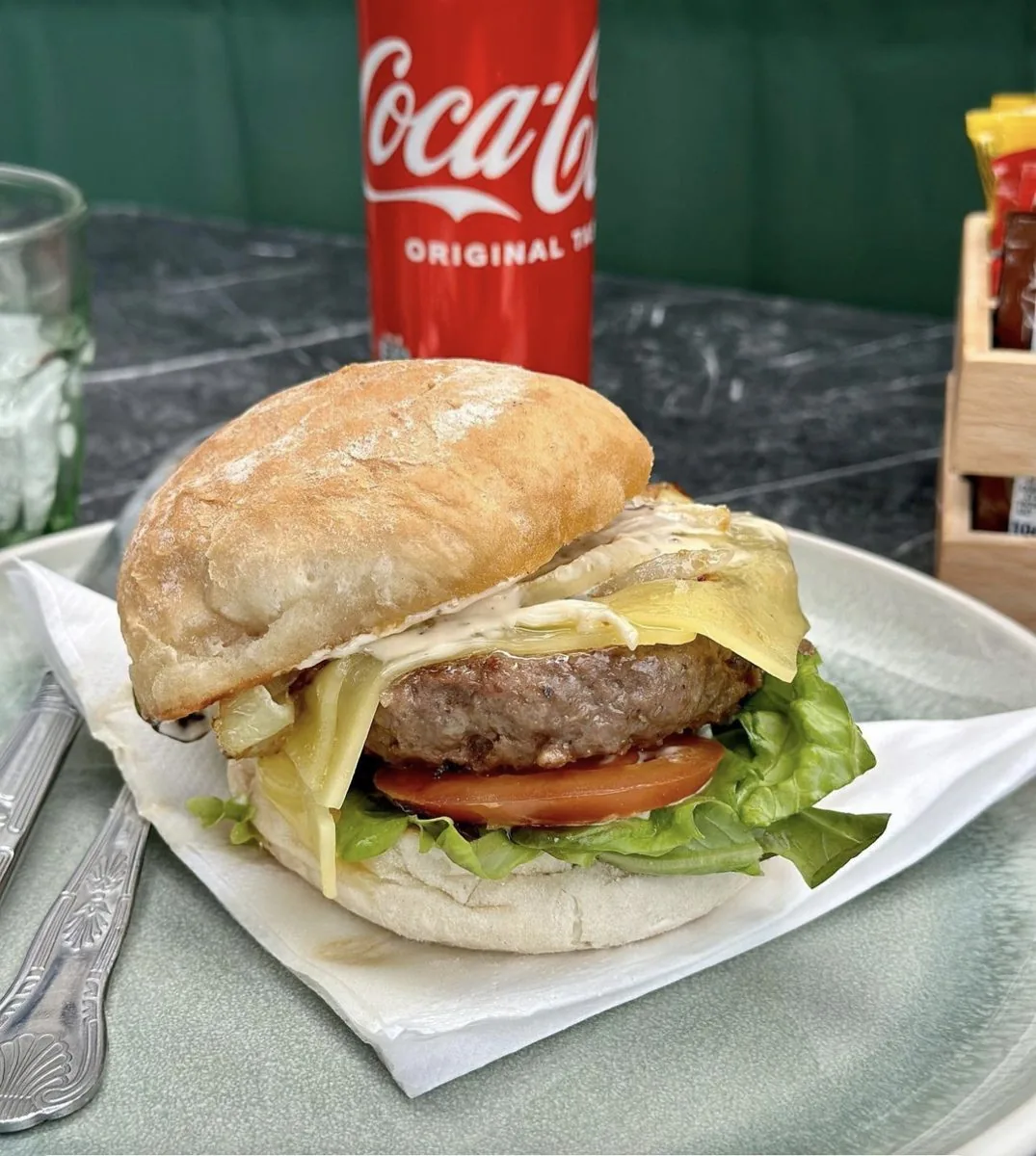 Beef burger with cheese, tomato and lettuce in a floury bap